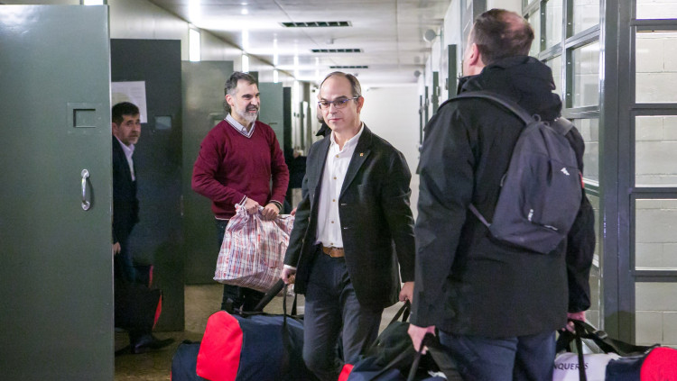 Pla general de Jordi Sànchez, Jordi Cuixart, Jordi Turull i Oriol Junqueras carregant unes bosses el dia del seu trasllat a Madrid pel judici de l'1-O l'1 de febrer de 2019. Agència Catalana de Notícies